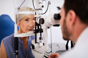 An eye doctor giving a woman an eye exam.